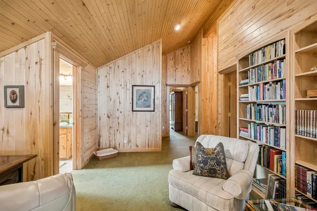 a living room with furniture and a book shelf