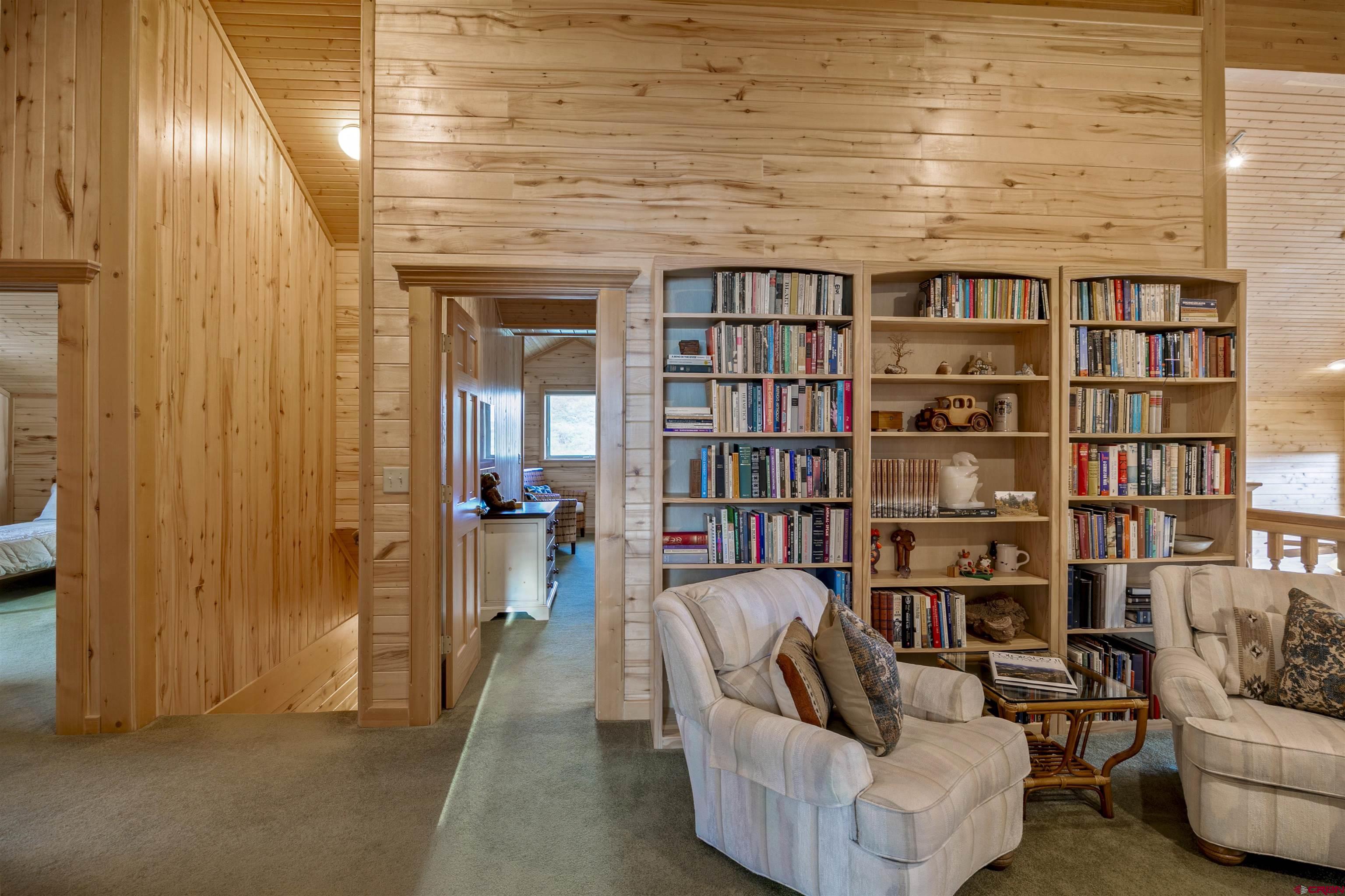 1100 Soaring Eagle Court Chromo, CO 81128 - Photo 26 of 44 a living room with furniture and a book shelf