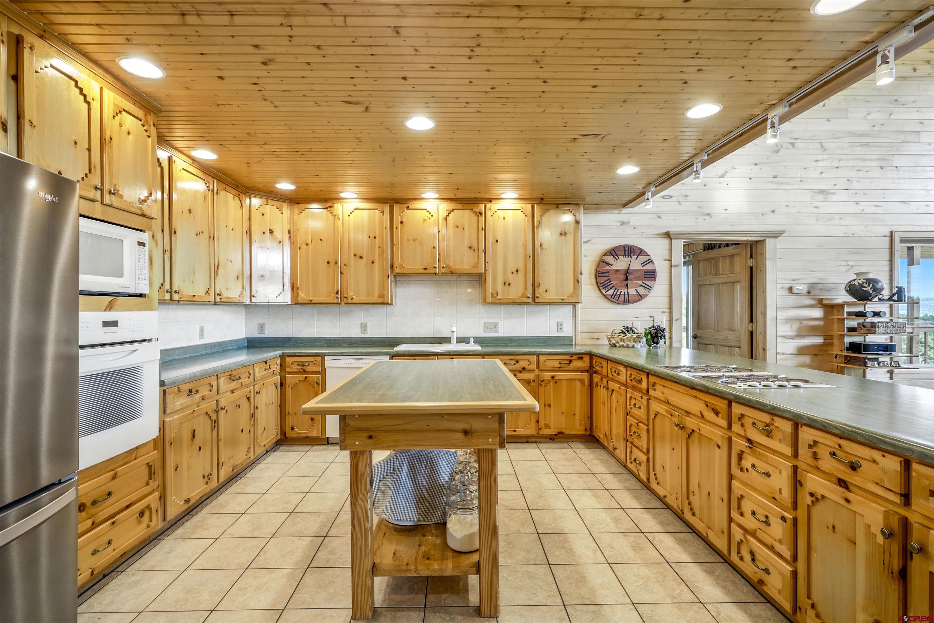1100 Soaring Eagle Court Chromo, CO 81128 - Photo 6 of 44 a kitchen with stainless steel appliances granite countertop a sink and cabinets