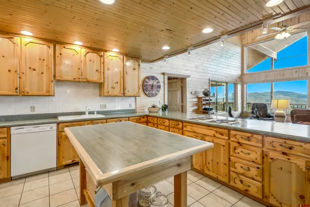 a kitchen with stainless steel appliances granite countertop a sink a stove counter space and cabinets
