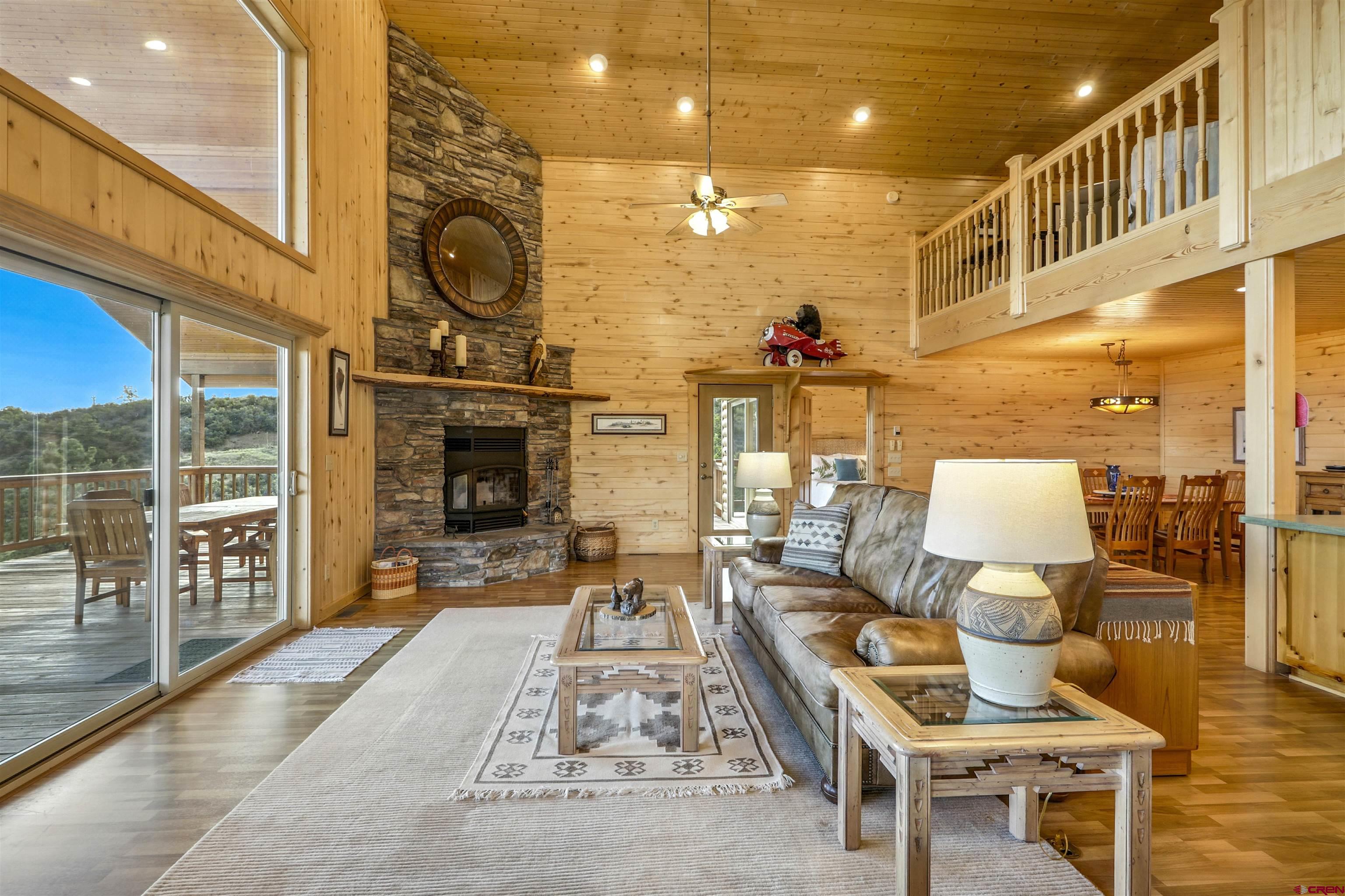 1100 Soaring Eagle Court Chromo, CO 81128 - Photo 8 of 44 a outdoor space with lots of furniture and wooden floor