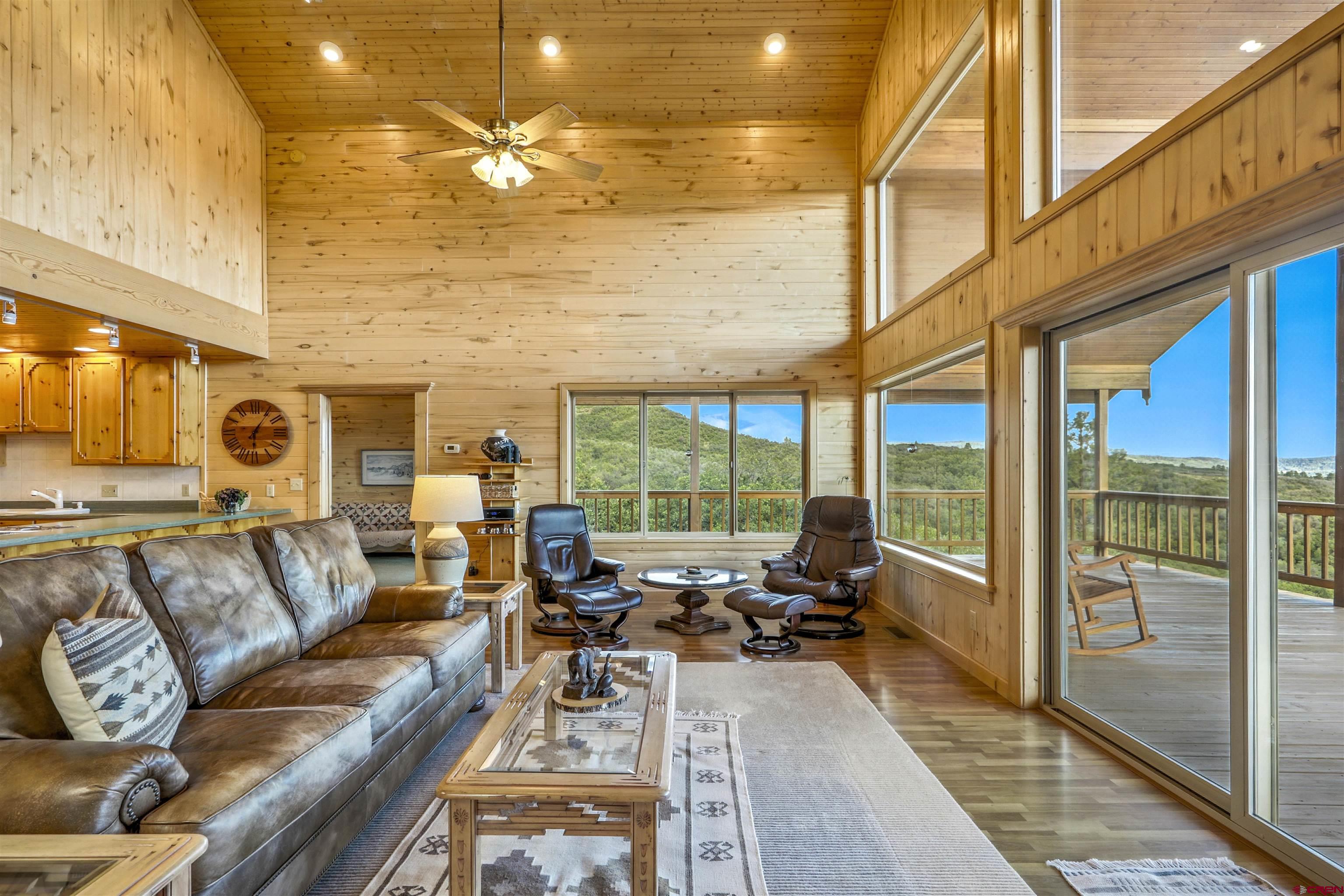 1100 Soaring Eagle Court Chromo, CO 81128 - Photo 10 of 44 a living room with furniture a rug and a floor to ceiling window