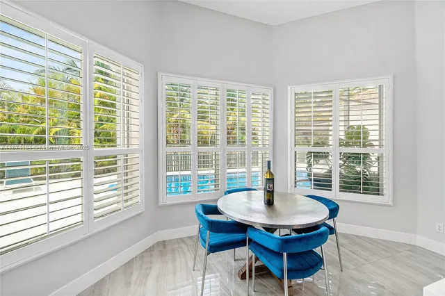 a dining room with furniture and wooden floor