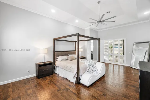 a bedroom with a bed and large mirror