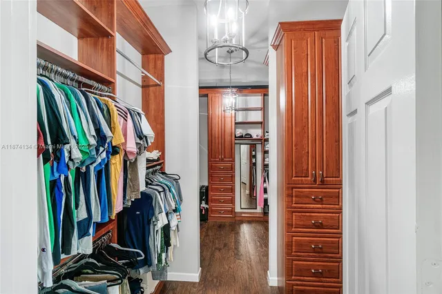 a view of walk in closet with clothes