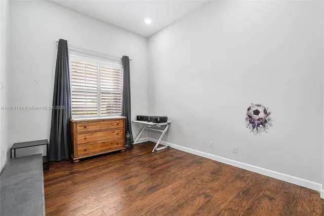 a view of room with a window and wooden floor