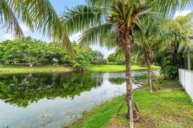 a view of a lake in a backyard of a house with a lake view