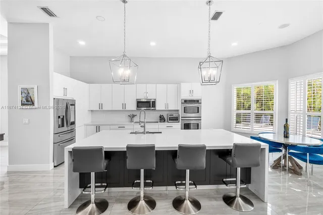 a large kitchen with a table and chairs