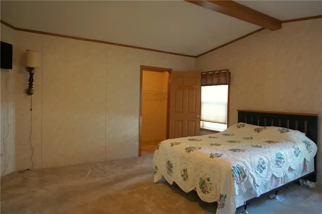 a bedroom with a bed and a window