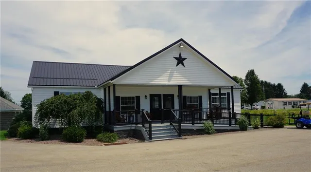 a front view of a house with garden and porch
