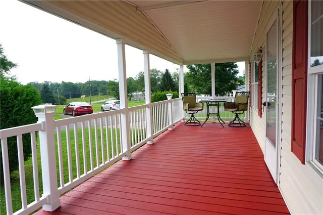 a view of deck with furniture and garden