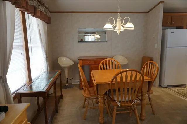 a view of a dining room with furniture and window