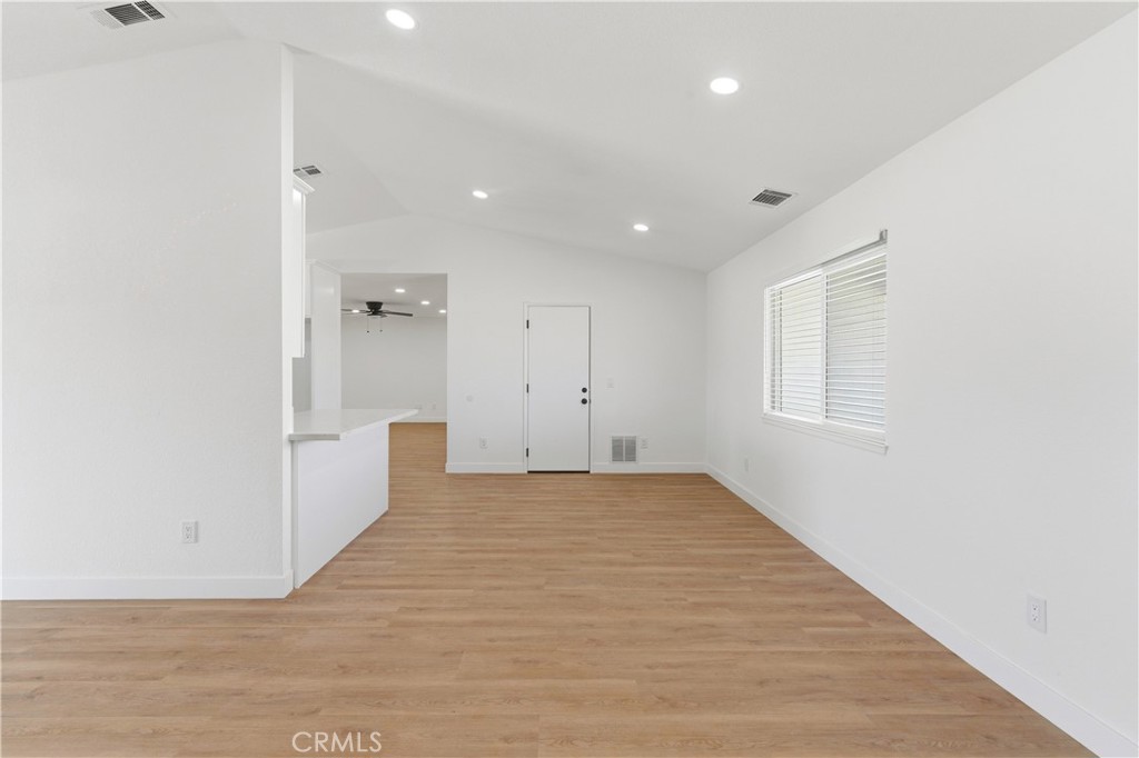 22557 Ojai Road Apple Valley, CA 92308 - Photo 14 of 57 a view of empty room with wooden floor