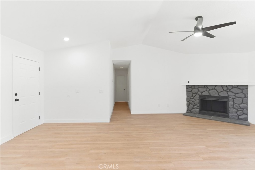 22557 Ojai Road Apple Valley, CA 92308 - Photo 17 of 57 a view of an empty room with a fireplace