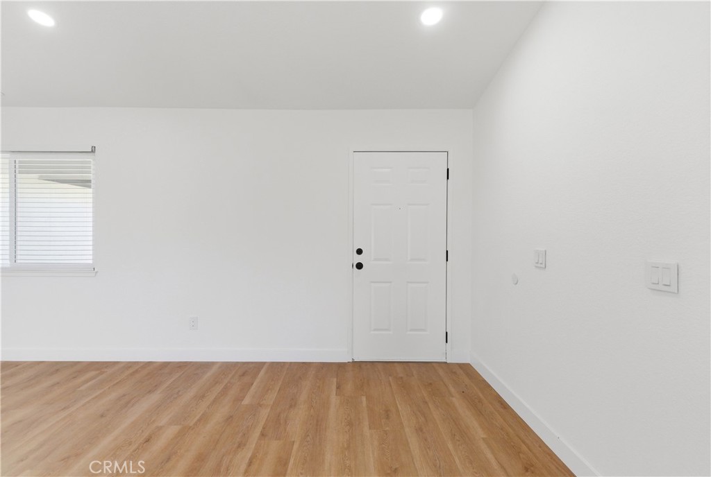 22557 Ojai Road Apple Valley, CA 92308 - Photo 18 of 57 a view of a room with wooden floor