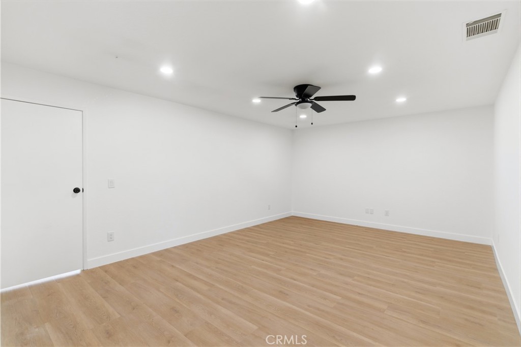 22557 Ojai Road Apple Valley, CA 92308 - Photo 19 of 57 a view of a room with a ceiling fan and wooden floor