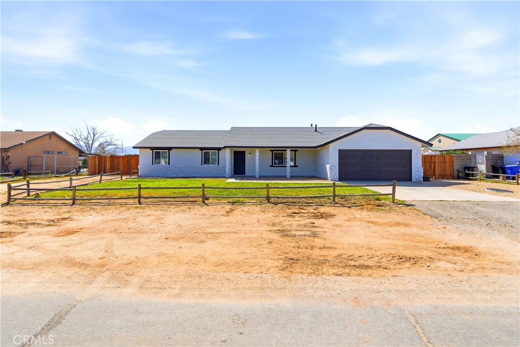 22557 Ojai Road Apple Valley, CA 92308 - Photo 2 of 57 a view of a large pool with lawn chairs and large trees