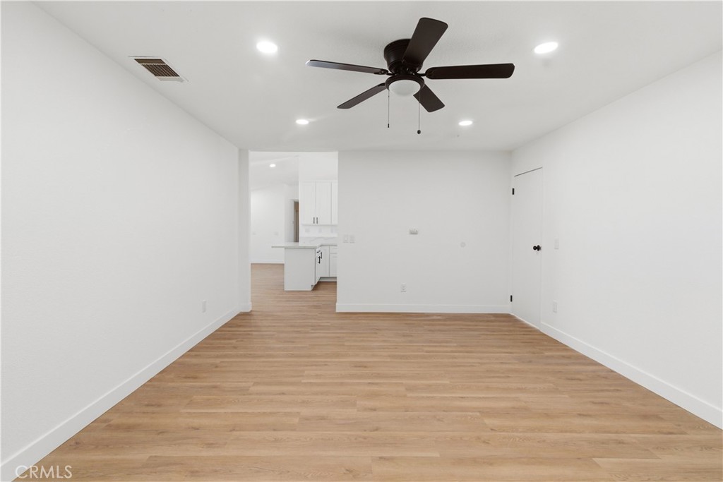 22557 Ojai Road Apple Valley, CA 92308 - Photo 22 of 57 a view of a big room with wooden floor and windows