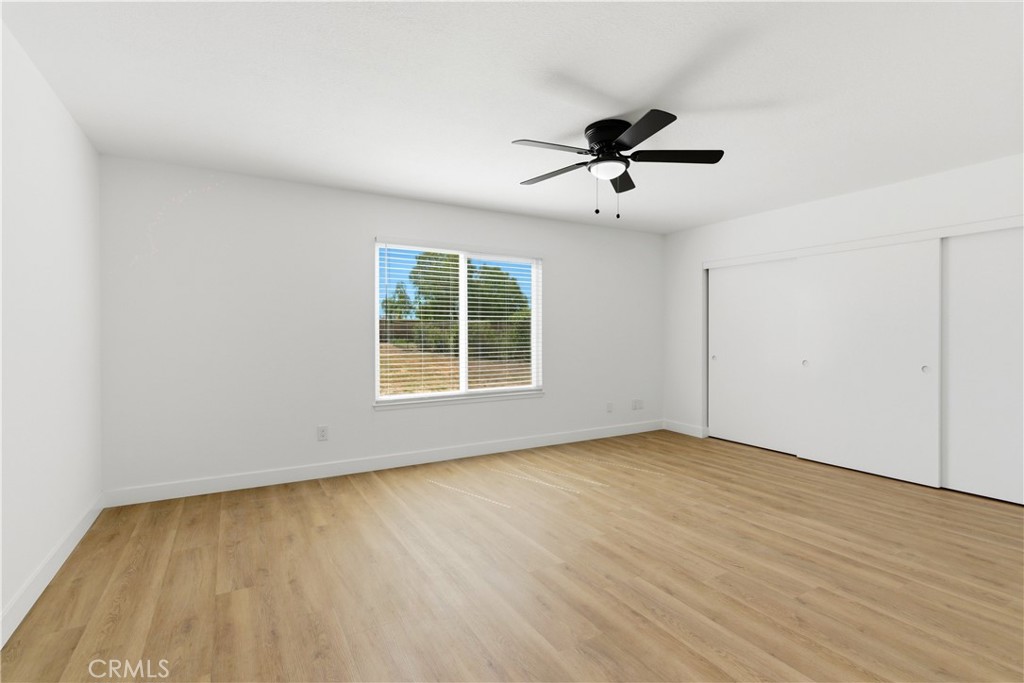 22557 Ojai Road Apple Valley, CA 92308 - Photo 23 of 57 wooden floor in an empty room with a window
