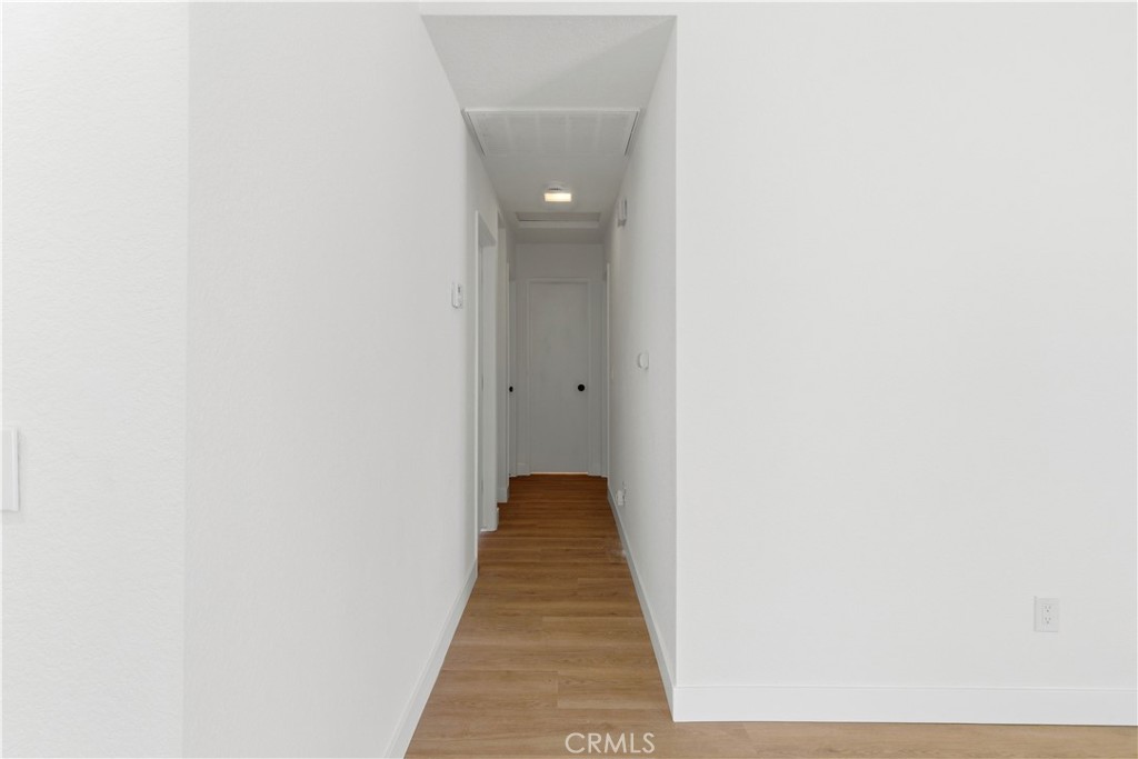 22557 Ojai Road Apple Valley, CA 92308 - Photo 25 of 57 a view of a hallway with wooden floor