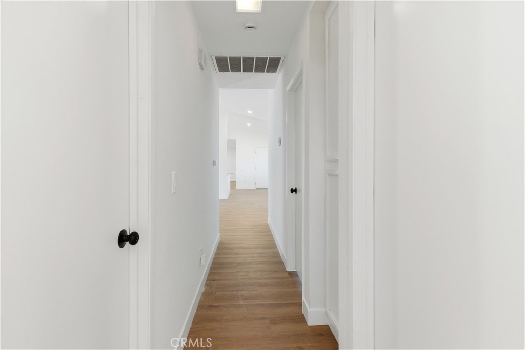 22557 Ojai Road Apple Valley, CA 92308 - Photo 26 of 57 a view of a hallway with wooden floor