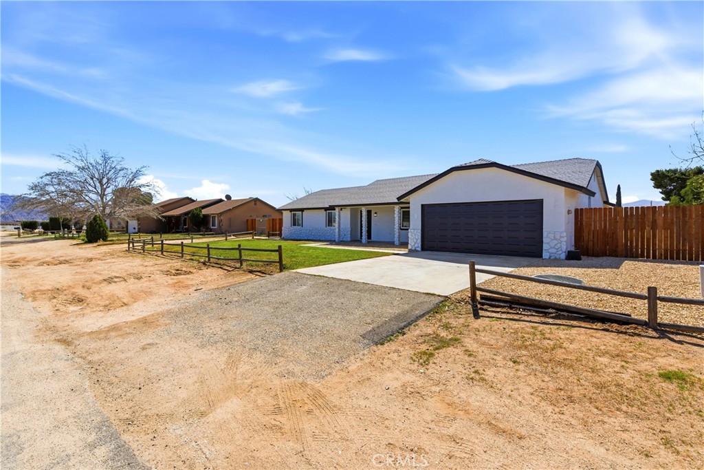 22557 Ojai Road Apple Valley, CA 92308 - Photo 4 of 57 a view of a house with a snow in the yard