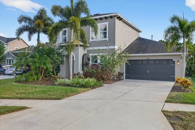 a front view of a house with a yard and garage