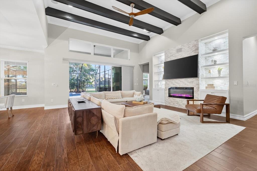 6609 Current Drive Apollo Beach, FL 33572 - Photo 11 of 47 a living room with furniture a fireplace and a flat screen tv