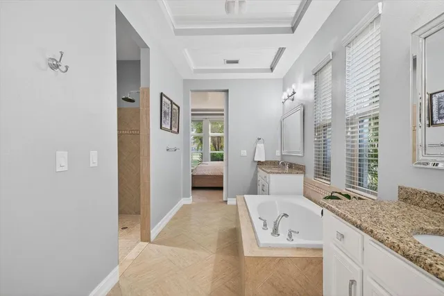 a spacious bathroom with a granite countertop sink and a large mirror