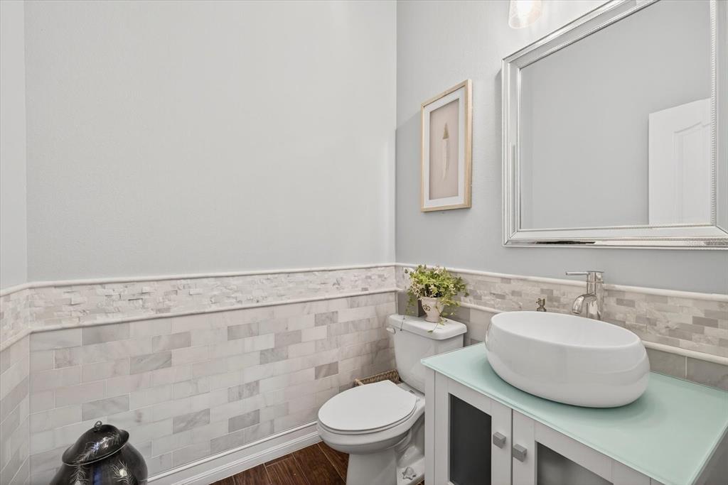 6609 Current Drive Apollo Beach, FL 33572 - Photo 26 of 47 a bathroom with a sink a toilet and a mirror