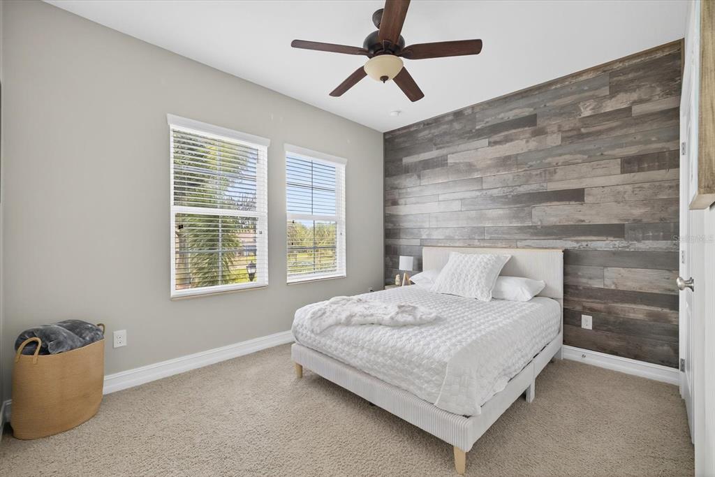 6609 Current Drive Apollo Beach, FL 33572 - Photo 30 of 47 a bedroom with a bed and a chandelier