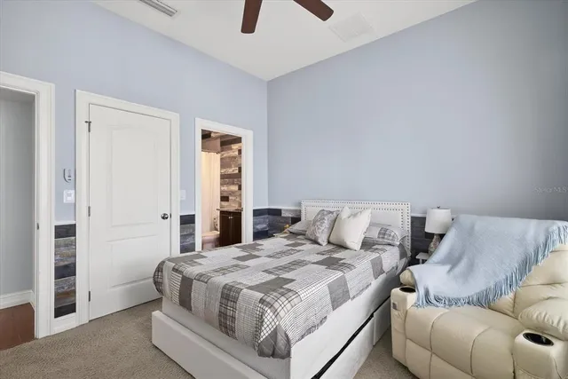 a bedroom with a bed and a couch