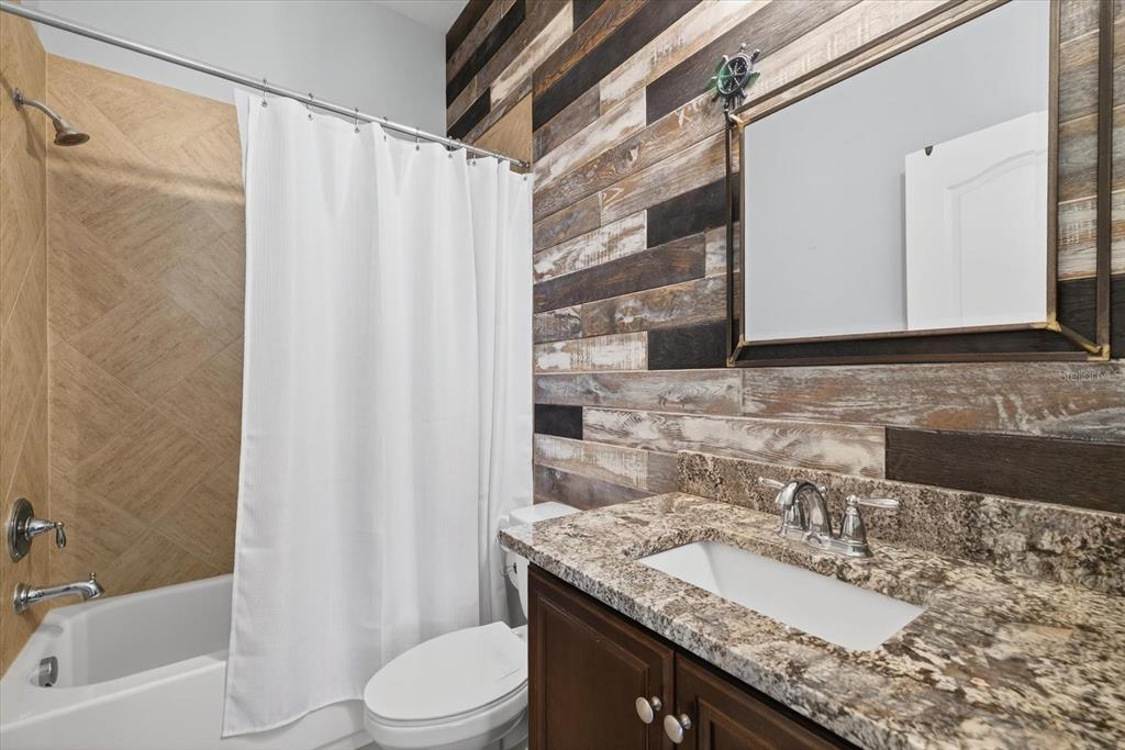 6609 Current Drive Apollo Beach, FL 33572 - Photo 35 of 47 a bathroom with a granite countertop sink toilet and shower