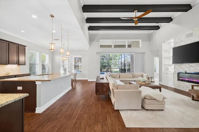 a living room with fireplace furniture and a flat screen tv