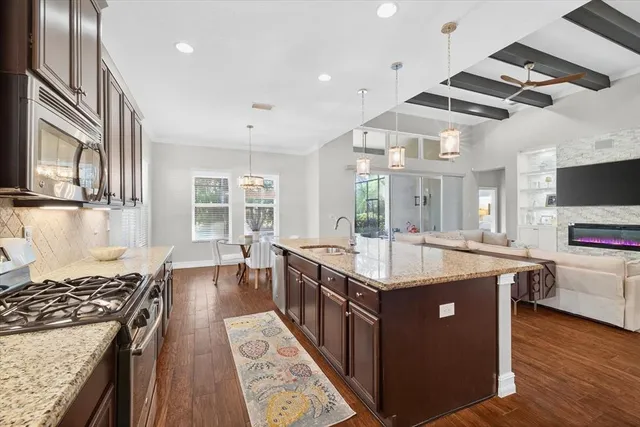 a kitchen with stainless steel appliances granite countertop a stove and a sink