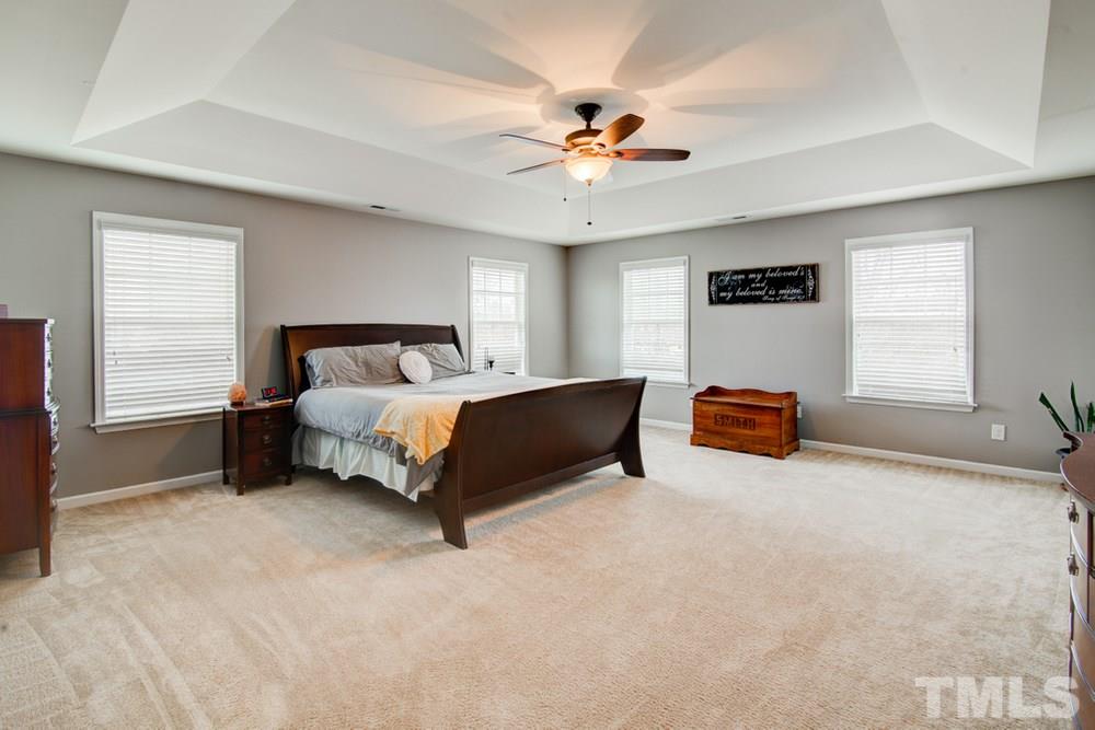 874 Seastone Street Raleigh, NC 27603 - Photo 14 of 30 a bedroom with a bed furniture and a window