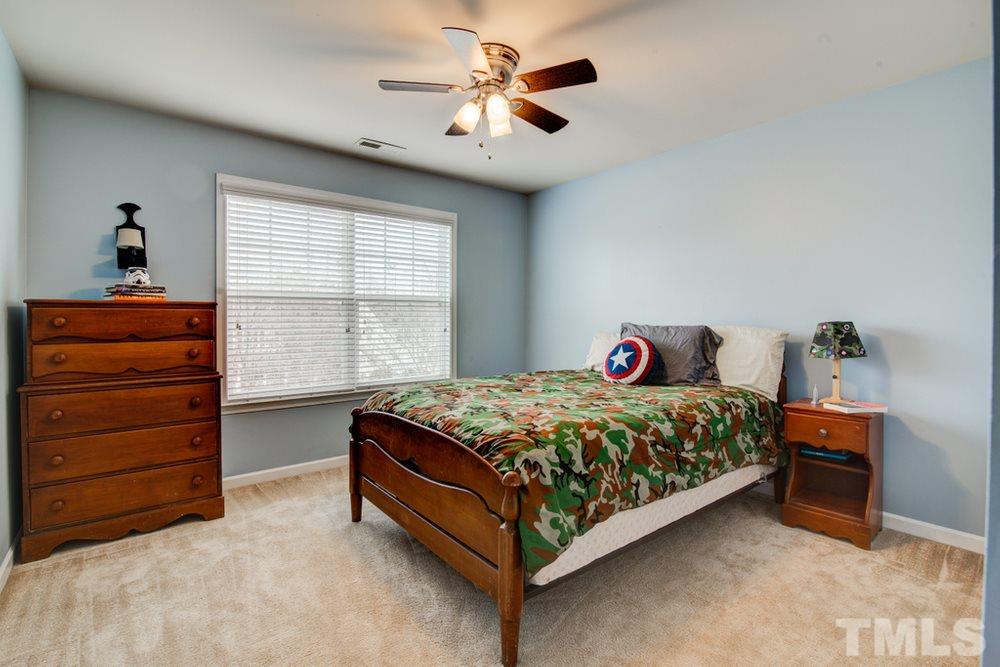 874 Seastone Street Raleigh, NC 27603 - Photo 23 of 30 a bedroom with a bed and a window