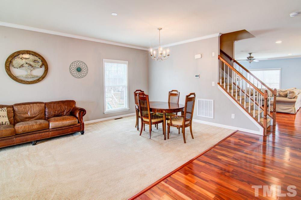 874 Seastone Street Raleigh, NC 27603 - Photo 5 of 30 a living room with furniture and a wooden floor