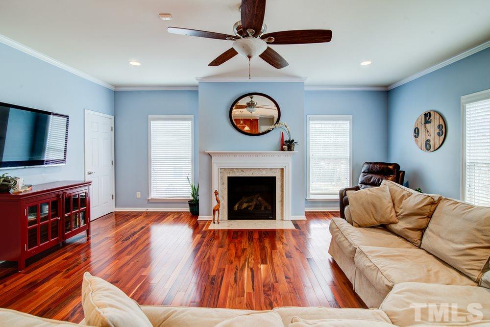 874 Seastone Street Raleigh, NC 27603 - Photo 8 of 30 a living room with furniture and a fireplace