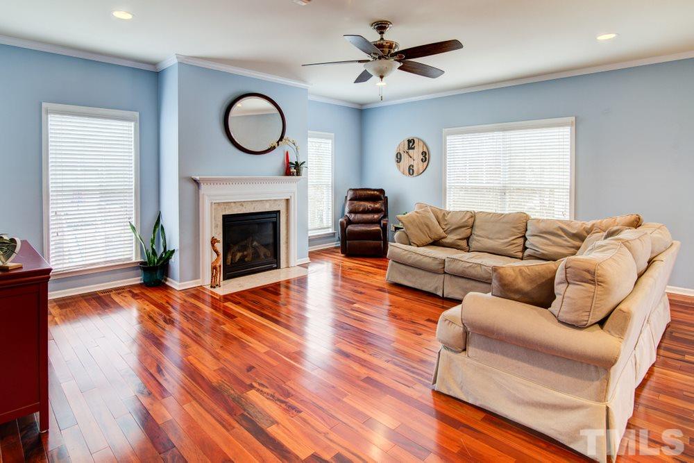 874 Seastone Street Raleigh, NC 27603 - Photo 9 of 30 a living room with furniture and a fireplace