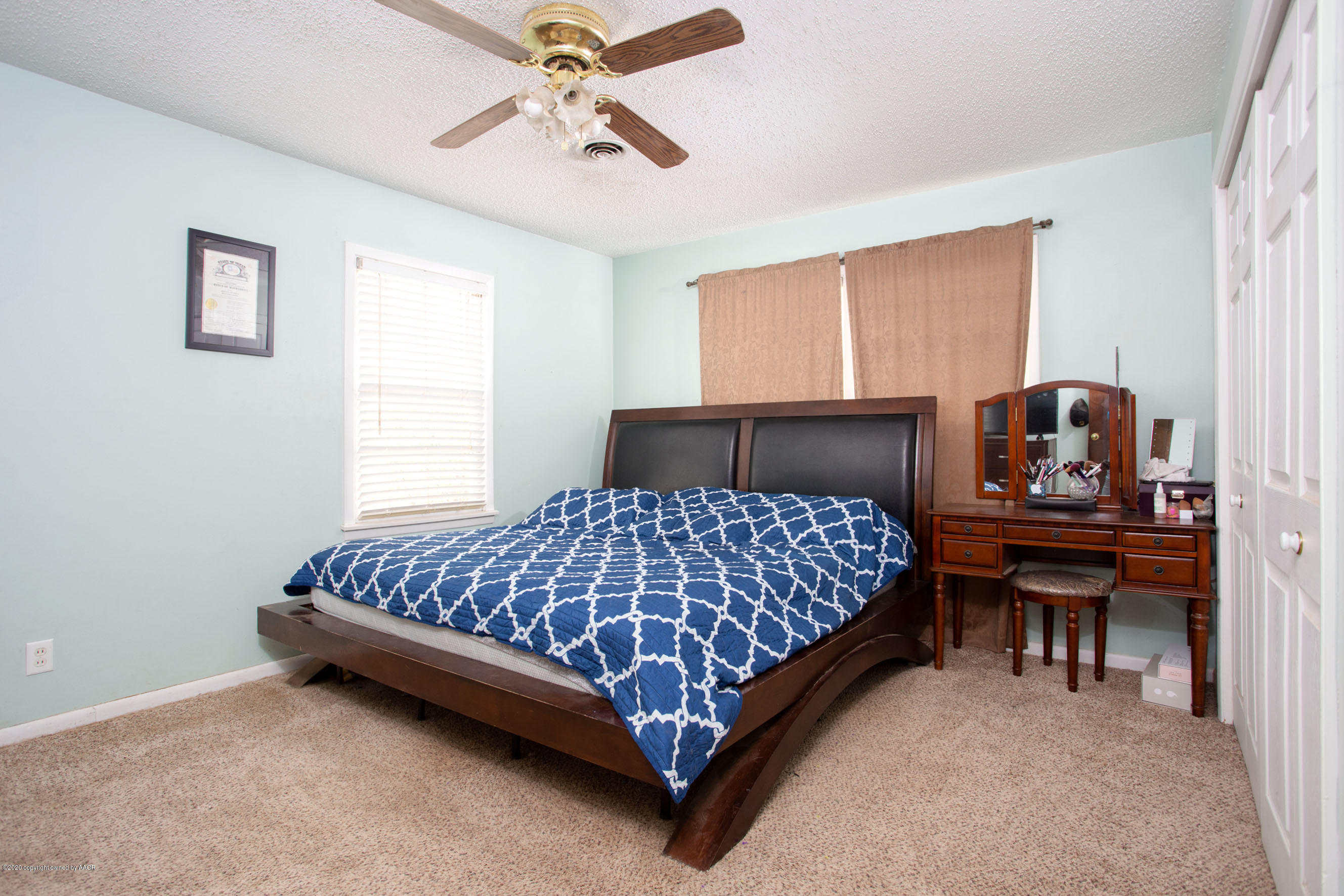 4712 South Milam Street Amarillo, TX 79110 - Photo 11 of 22 a bedroom with a bed table chair and window