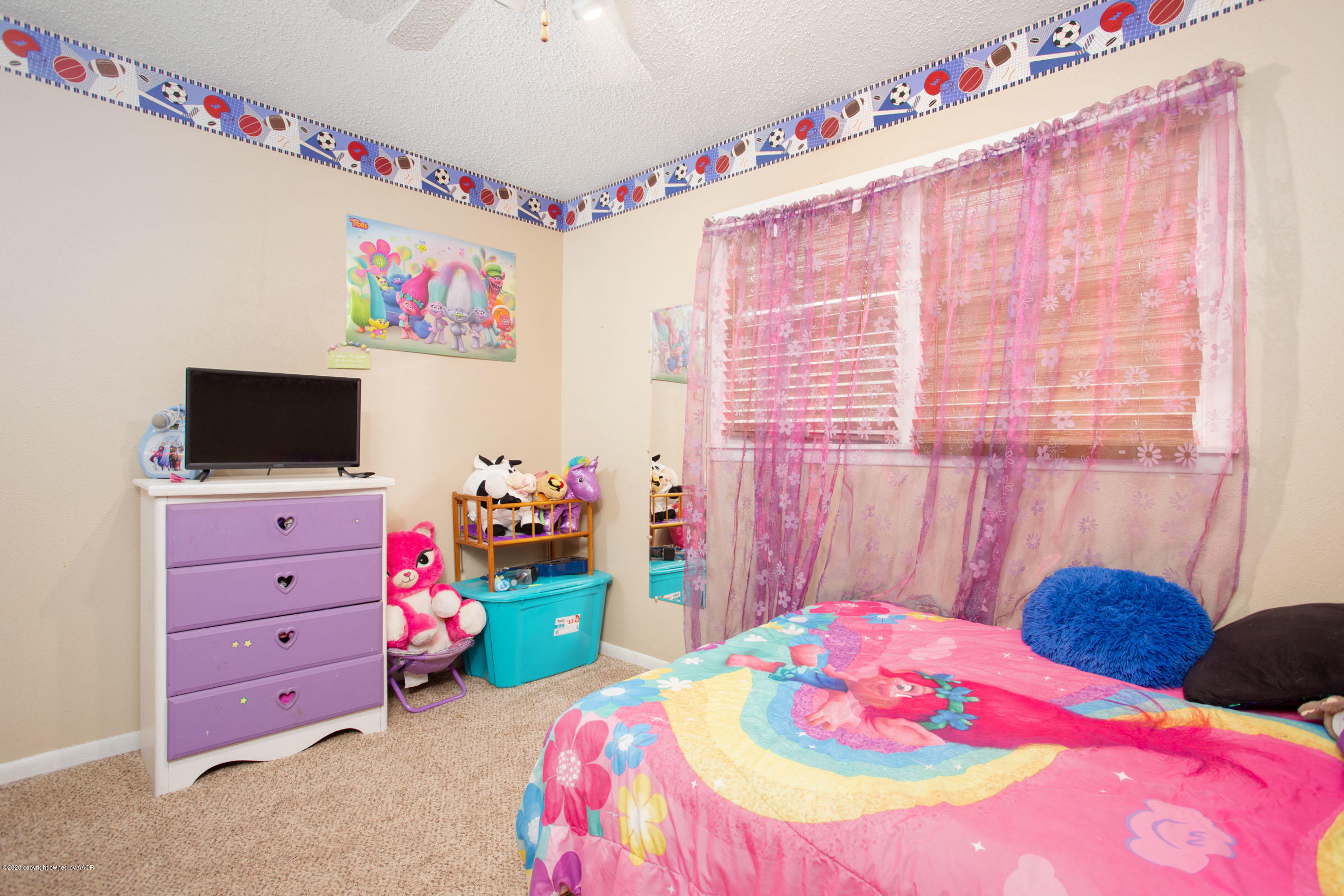 4712 South Milam Street Amarillo, TX 79110 - Photo 16 of 22 a bedroom with a bed a couch and a window