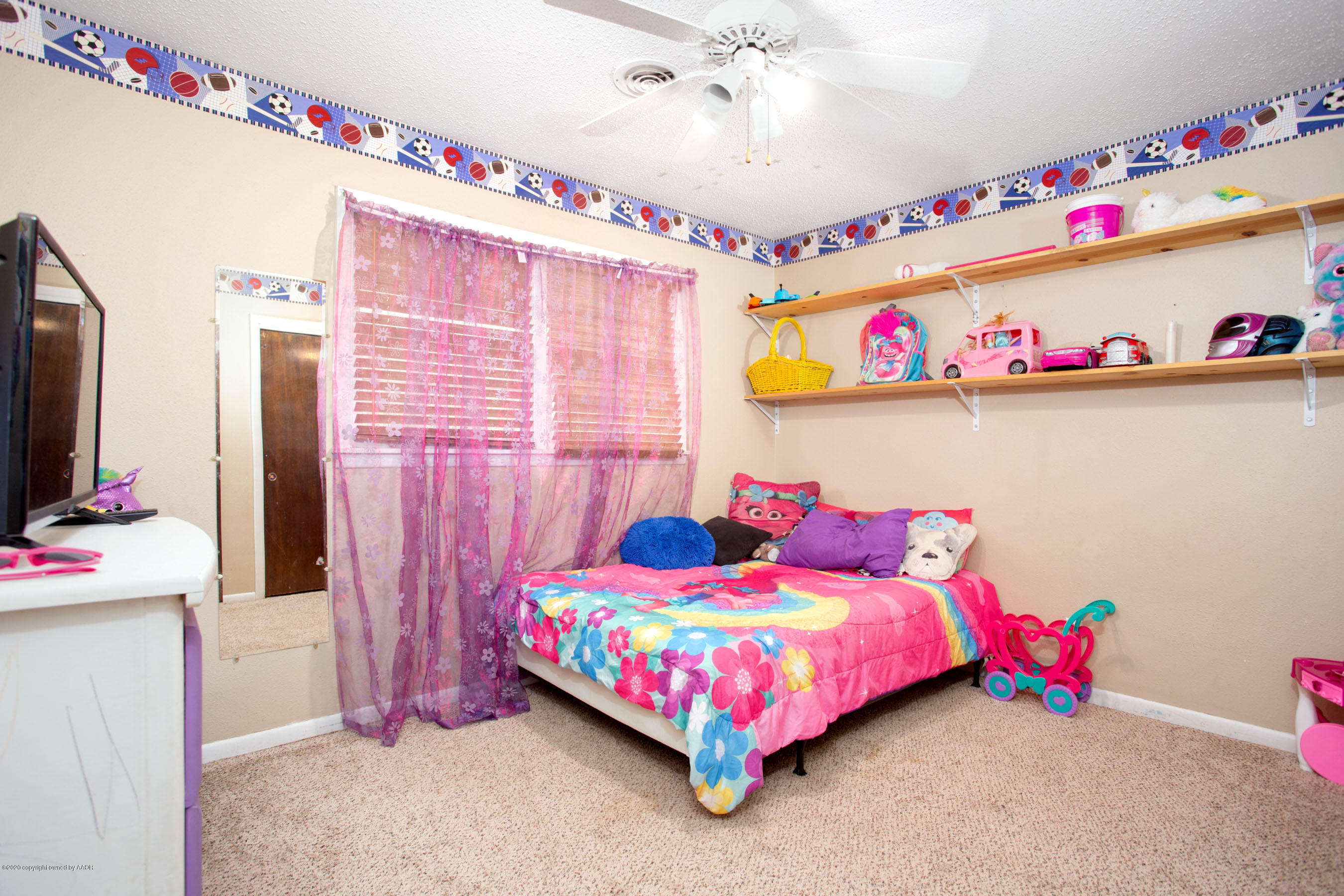 4712 South Milam Street Amarillo, TX 79110 - Photo 17 of 22 a bedroom with a bed and a flat screen tv