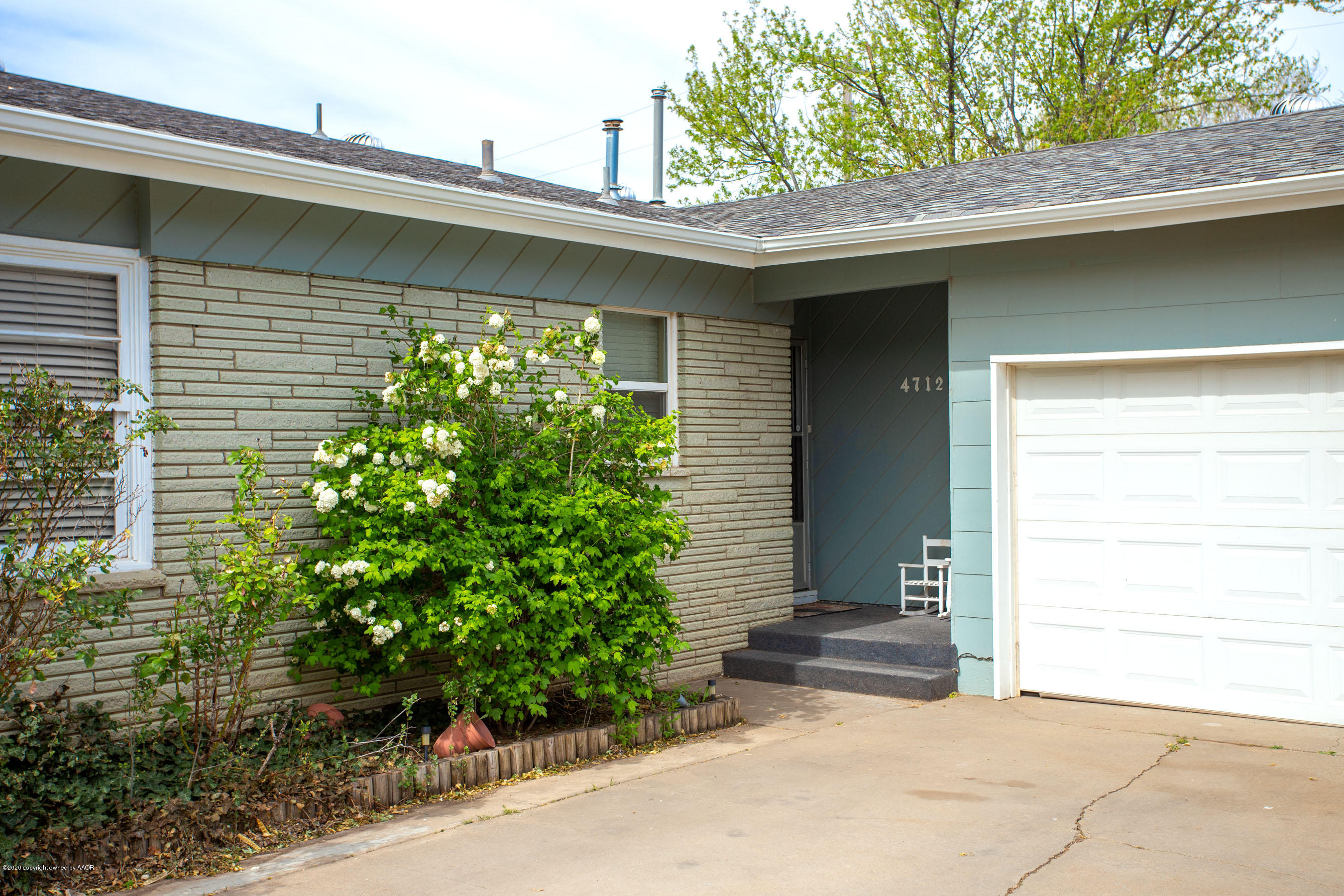 4712 South Milam Street Amarillo, TX 79110 - Photo 2 of 22 a couple of potted plants in front of door