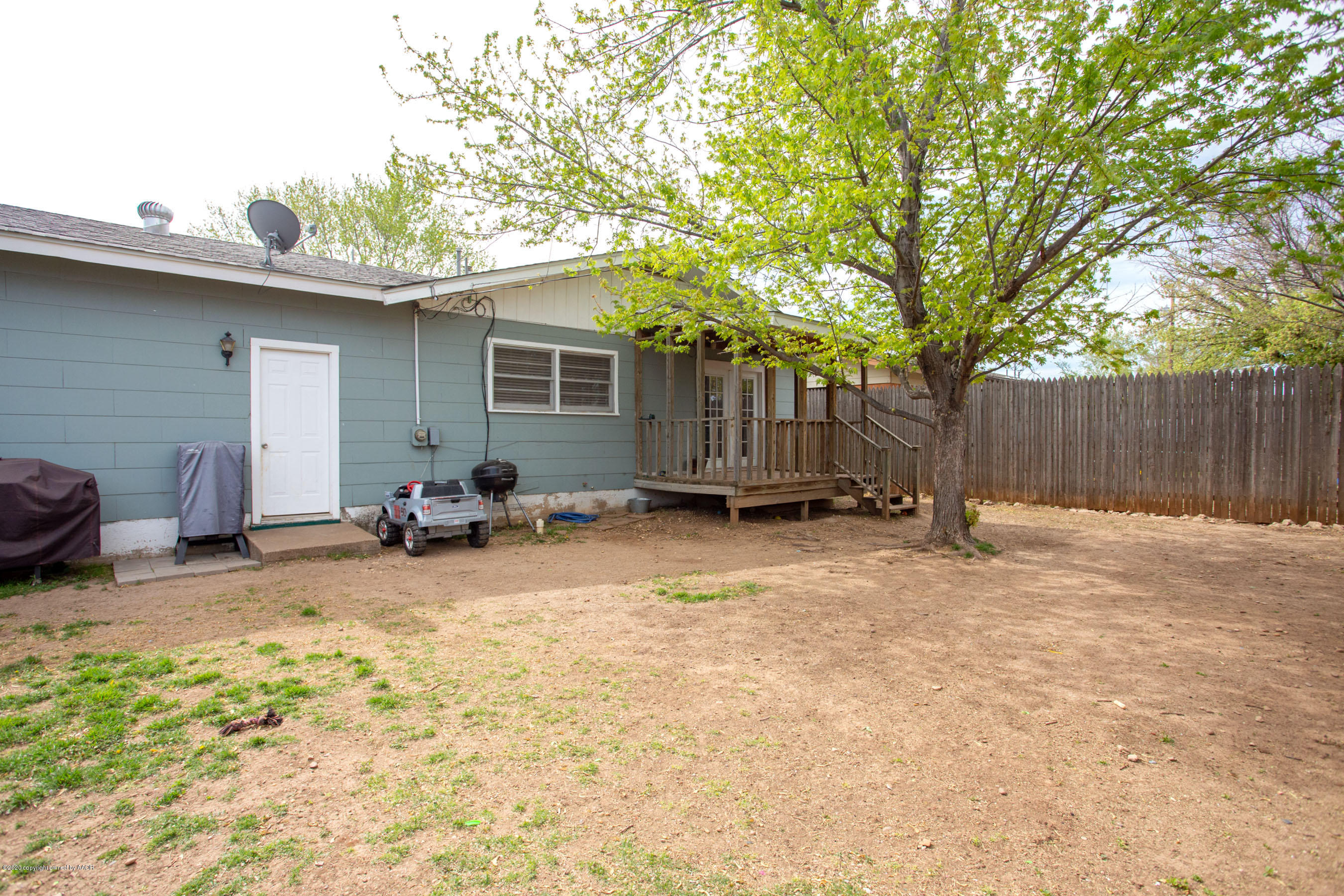4712 South Milam Street Amarillo, TX 79110 - Photo 21 of 22 a view of a backyard with a small cabin and a chair