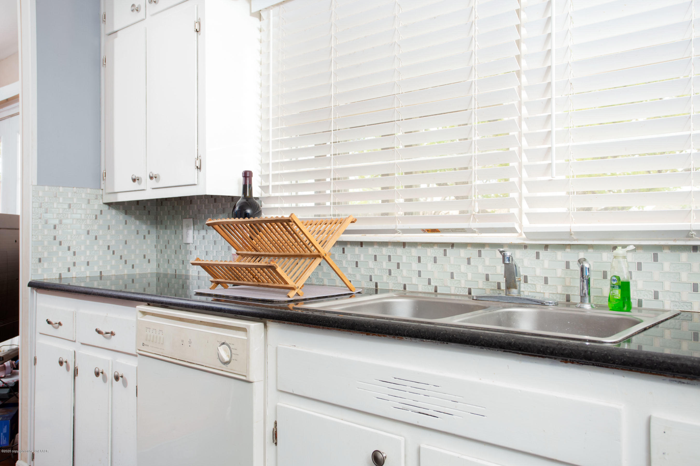 4712 South Milam Street Amarillo, TX 79110 - Photo 5 of 22 a kitchen with a sink and a window