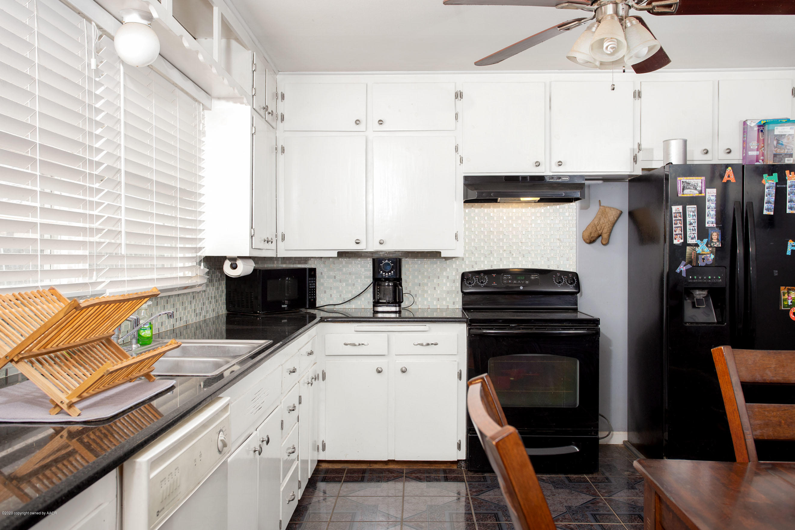 4712 South Milam Street Amarillo, TX 79110 - Photo 6 of 22 a kitchen with stainless steel appliances kitchen island granite countertop a stove top oven a sink a counter space and cabinets