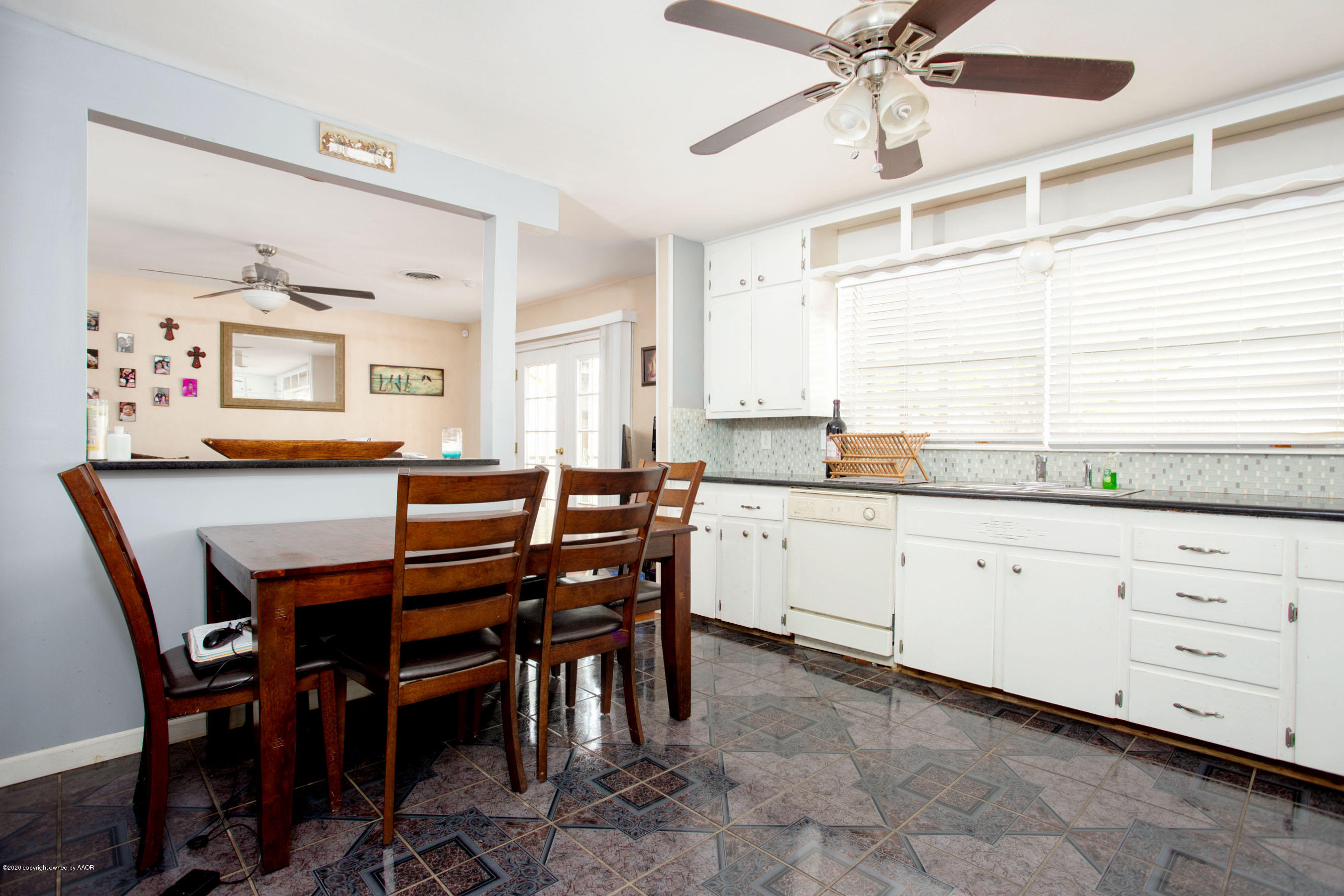 4712 South Milam Street Amarillo, TX 79110 - Photo 7 of 22 a open dining room with stainless steel appliances kitchen island granite countertop furniture and a window