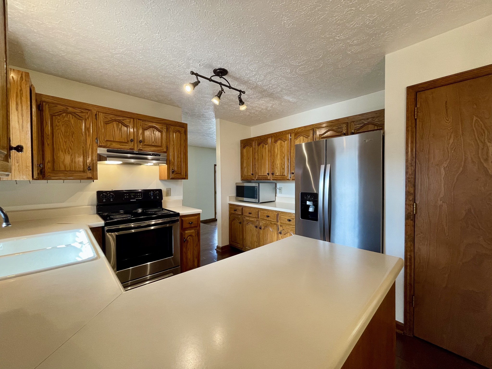 2911 New Hope Road Hendersonville, TN 37075 - Photo 11 of 27 a kitchen with stainless steel appliances granite countertop a refrigerator stove top oven and sink