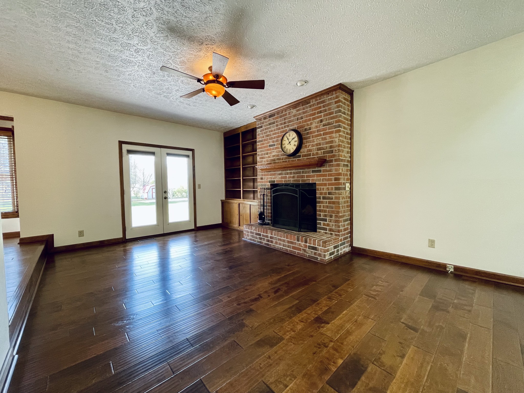 2911 New Hope Road Hendersonville, TN 37075 - Photo 7 of 27 an empty room with wooden floor fireplace and windows
